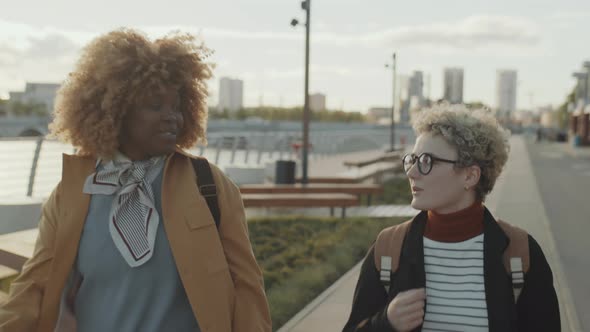 Multiethnic Female Friends Walking Outdoors and Chatting