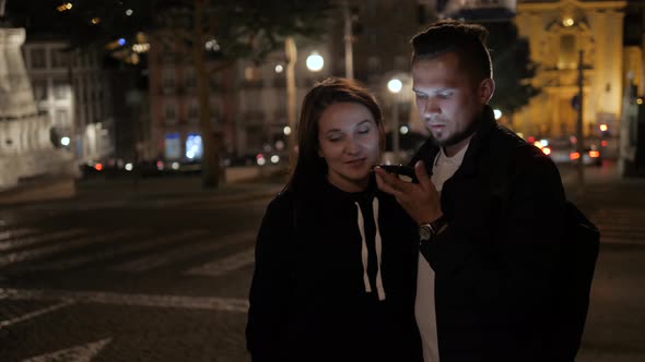 Man and Woman Couple Voice Recognition with Smart Phone Near Cafe Restaurant Waiting Order Student