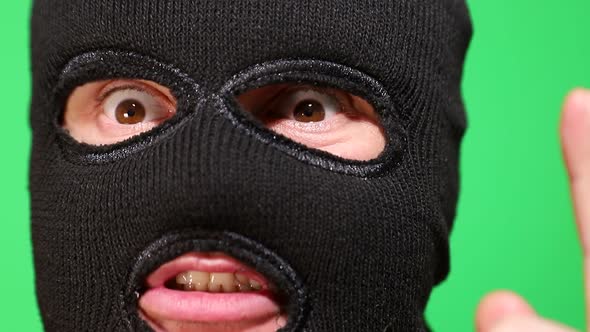 Scary Thief or Robber in Mask Looking at Camera