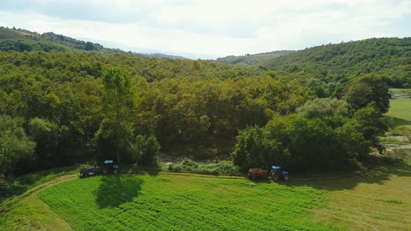 Tractor in Farmland Among the Bushes