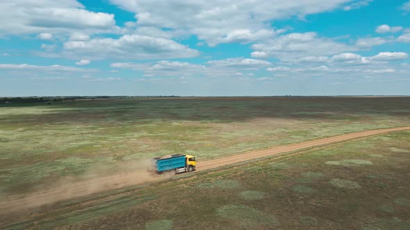 Aerial View Car and Truck Moving By Rustic Road Through Green Fields