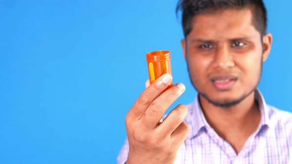 a Worried Young Man Hand Holding Pill Container 