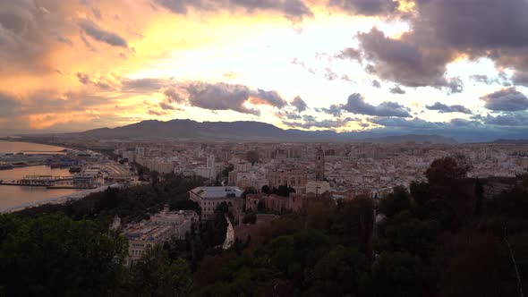 Stunning sunset view over Malaga City with clouds. Locked off shot