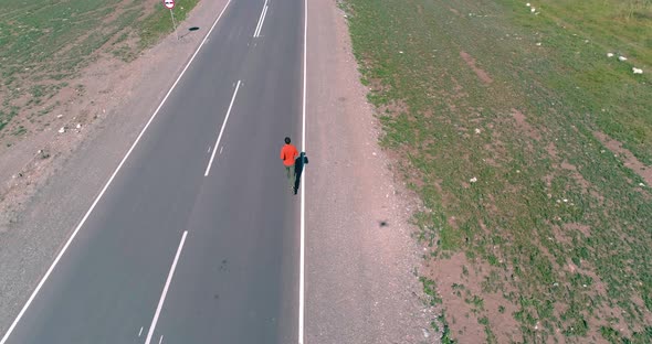 Low Altitude Flight Over Sporty Man at New Asphalt Road