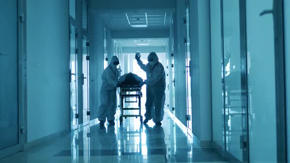 Emergency Doctors Transfer a Man with Coronavirus on Stretcher.