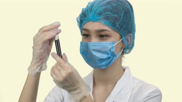 Young Woman Doctor in Protective Mask with Blood Test Tube