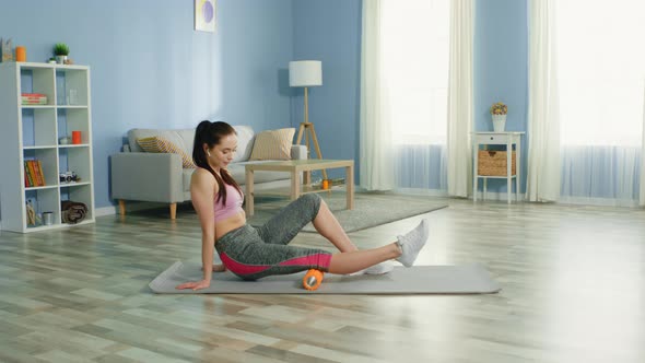 Young Woman Is Doing Foam Roller Exercise