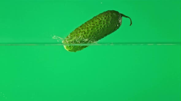 Super Slow Motion One Cucumber Falls Into Water with Splashes