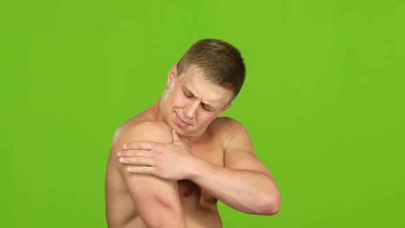 Athlete Suffers From Spasm in Shoulder, Side View. Green Screen