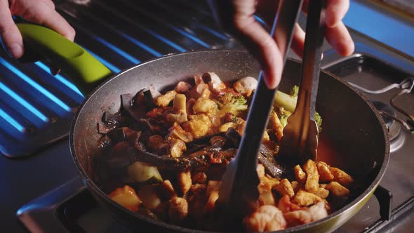 Cooking Dinner, Person Stirring in Chicken Noodles With Vegetables