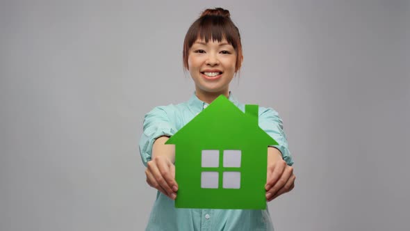 Smiling Asian Woman Holding Green House