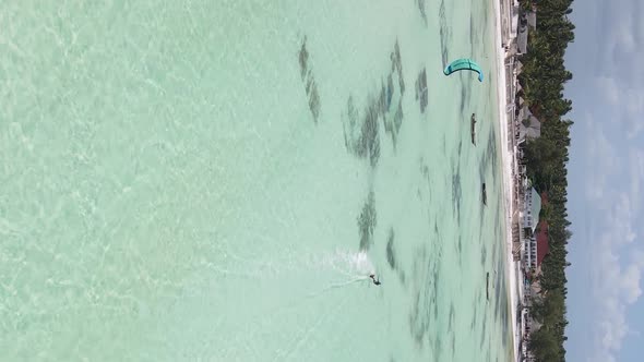 Zanzibar Tanzania  Vertical Video Kitesurfing Near the Shore of Ocean Slow Motion