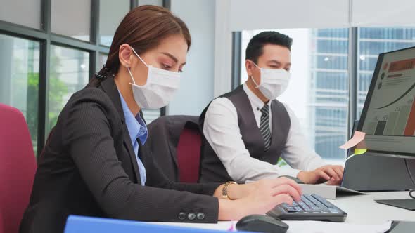 Group of Asian team business people man and woman wear face mask, working in office with new normal