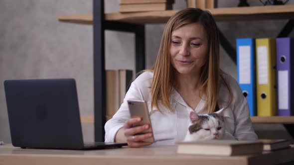 Smiling Female Having Fun in Social Media at Work