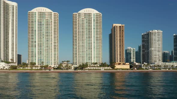 Beautiful City Skyline at Sunrise. White Buildings Reflecting in Atlantic Ocean