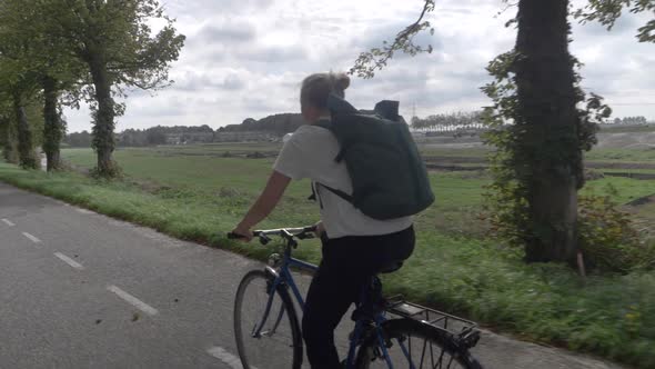 Young Determined Woman Cycling Home Through the Beautiful Dutch Countryside