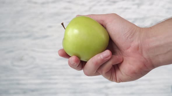 Green apple close-up in hand 