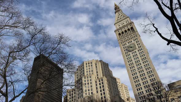 Madison Square Park in NYC timelapse of clouds behind clock tower and 2 other buildings