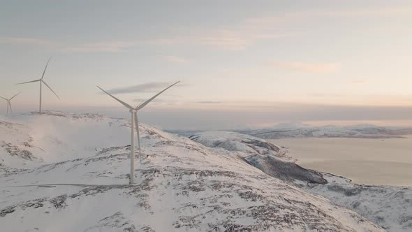 Wind Turbine Producing Renewable Energy In Fjord Landscape, Aerial