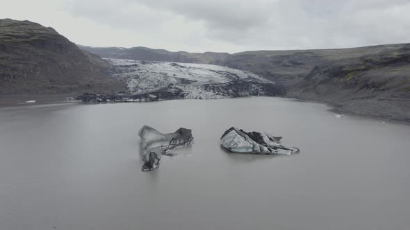 Aerial drone view over ice blocks, towards the Solheimajokull Glacier, in Iceland