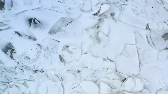 Flying Above Frozen Ice on Lake. Inspirational Drone Video. Aerial Footage of Melting Ice in Winter