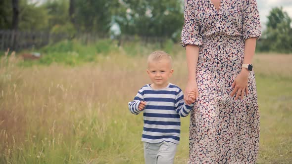 Little Son Relaxing Carefree Mother. Mom Playing Cute Little Child Boy On Park.Joyful Parent And Boy