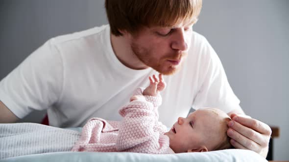 Caressing Dad Soothing and Kissing Baby Daughter