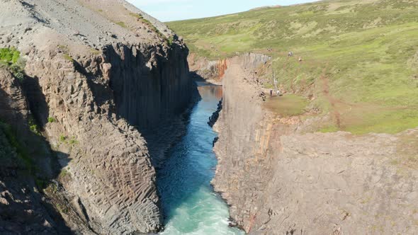 Aerial View of Jokulsa River Flowing Through Columns of Volcanic Basalt Formations in Stuolagil