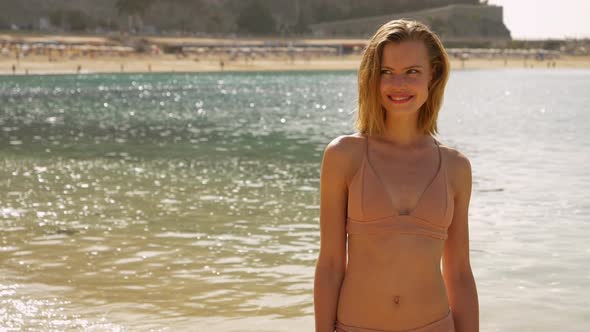 Beautiful Model Biting Her Lip With Sea Water in the Background