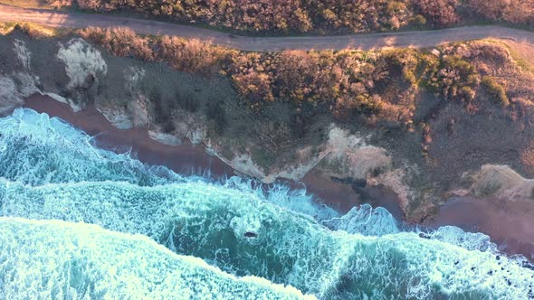 Aerial view to a beautiful wild rocky beach and big waves