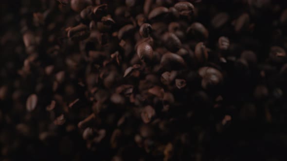 Coffee beans fly after being exploded. Slow Motion.