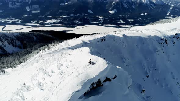 Skiers standing on a snow capped mountain 4k