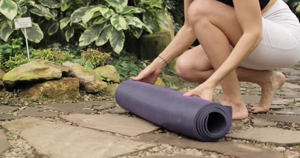 Closeup of Woman's Legs Caming to the Beautiful Botanical Garden for Doing Yoga Exercises