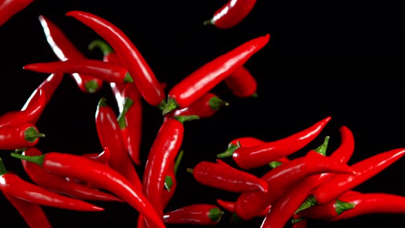 Super Slow Motion Shot of Flying Red Chilli Peppers in the Air at 1000Fps