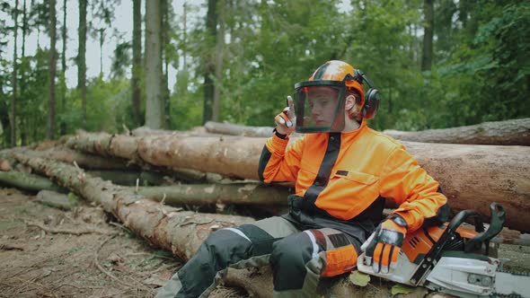 Hard Work Portrait of a Female Logger Sitting in the Forest Young Specialist in Protective Gear