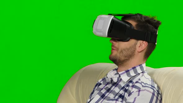 Guy Watches the Plot of Mask of Virtual Reality. Green Screen