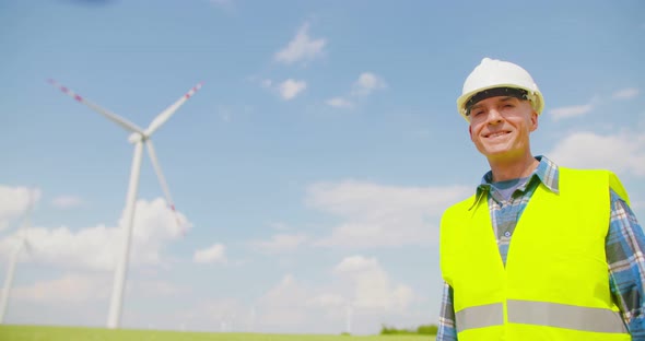 Engineer with Blueprint Analyzing Farm Against Sky