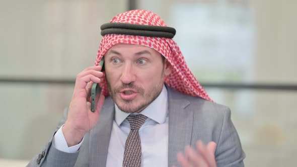 Portrait of Middle Aged Arab Businessman Talking Angrily on Smartphone