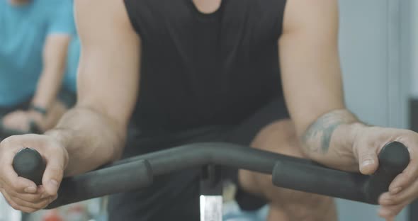Unrecognizable Caucasian Sportsman with Tattoo on Hand Putting Palms on Handlebar. Strong Young Man alt