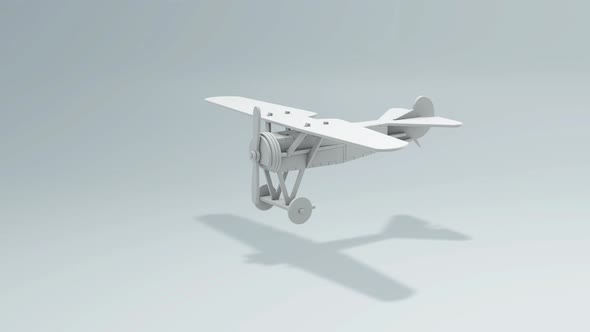 The White Plane Toy With Spinning Propeller Rotates Around its Axis.