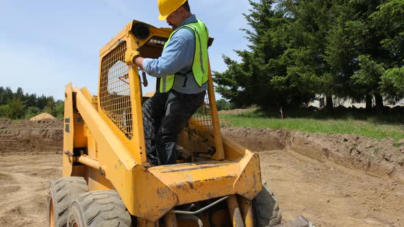 Worker driving excavator alt