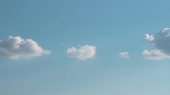 Puffy fluffy white clouds timelapse. Blue sky white clouds. Cumulus cloud cloudscape at Summer blue