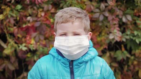 Portrait of Boy in Medical Mask on Street in City