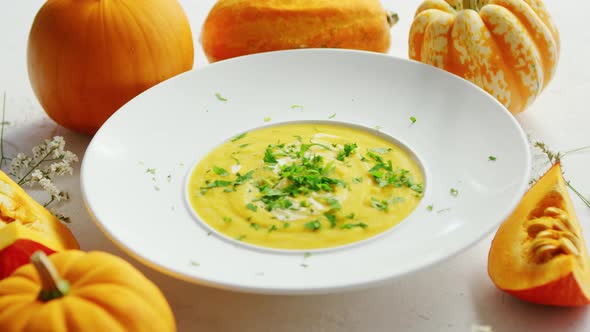 Soup in Plate with Pumpkins Around