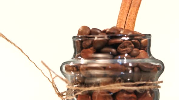 Top of Little Spinning Bottle with Coffee Beans and Cinnamon Close Up, Rotation