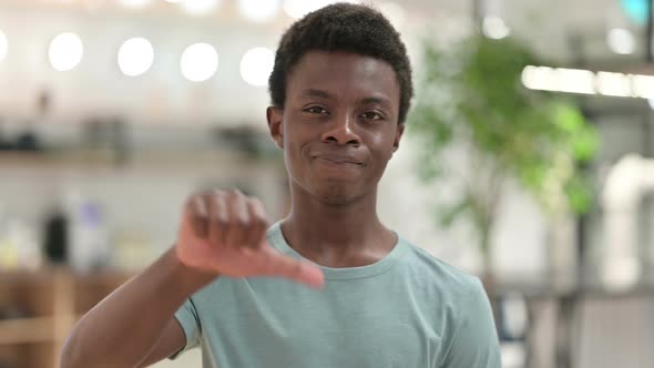 Young African Man Doing Thumbs Down 