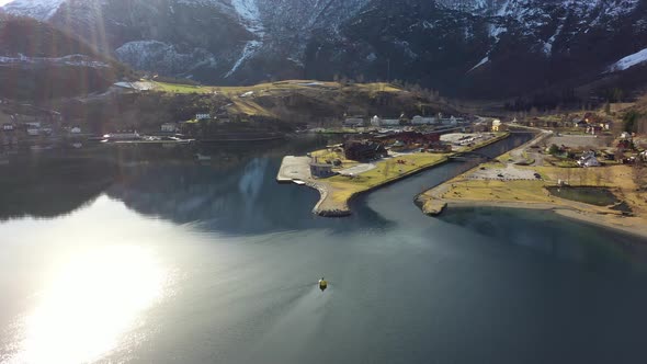 Flam and Aurlandsfjord beautiful aerial view with sunrays from top left corner and bright reflection