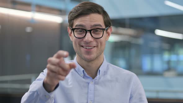 Portrait of Young Man Pointing at Camera Inviting