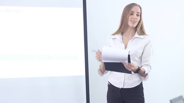 Business Woman Reading Business Report At The Office