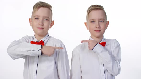 Blond Identical Twins Posing in Studio for Family Album